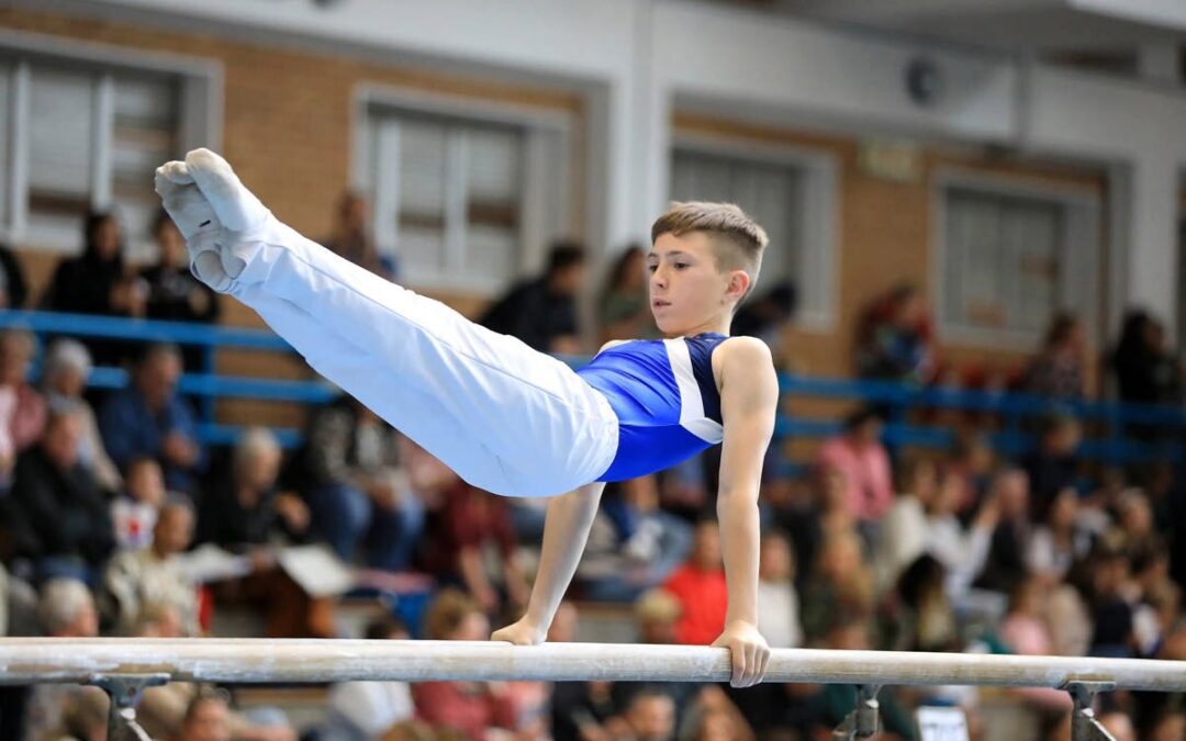 Thirteen-year-old gymnast Xavier Snyman performing a controlled handstand in a training gym.