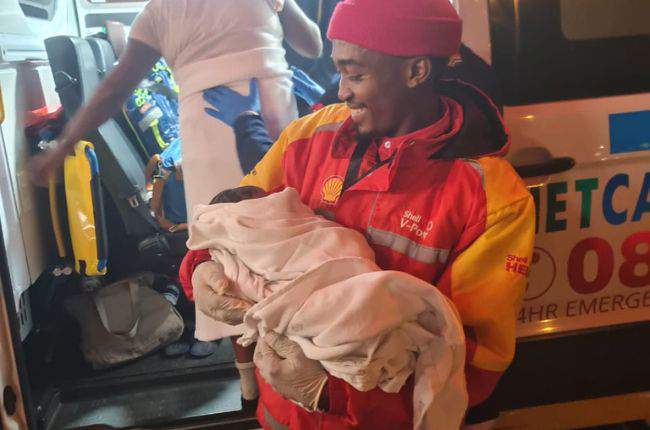 Petrol attendant Chevaan Abrahams smiling at the service station where he helped deliver a baby.