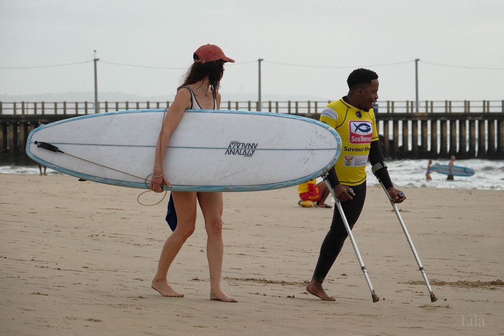 Emihle Sombexe riding a wave as a South African para surfer