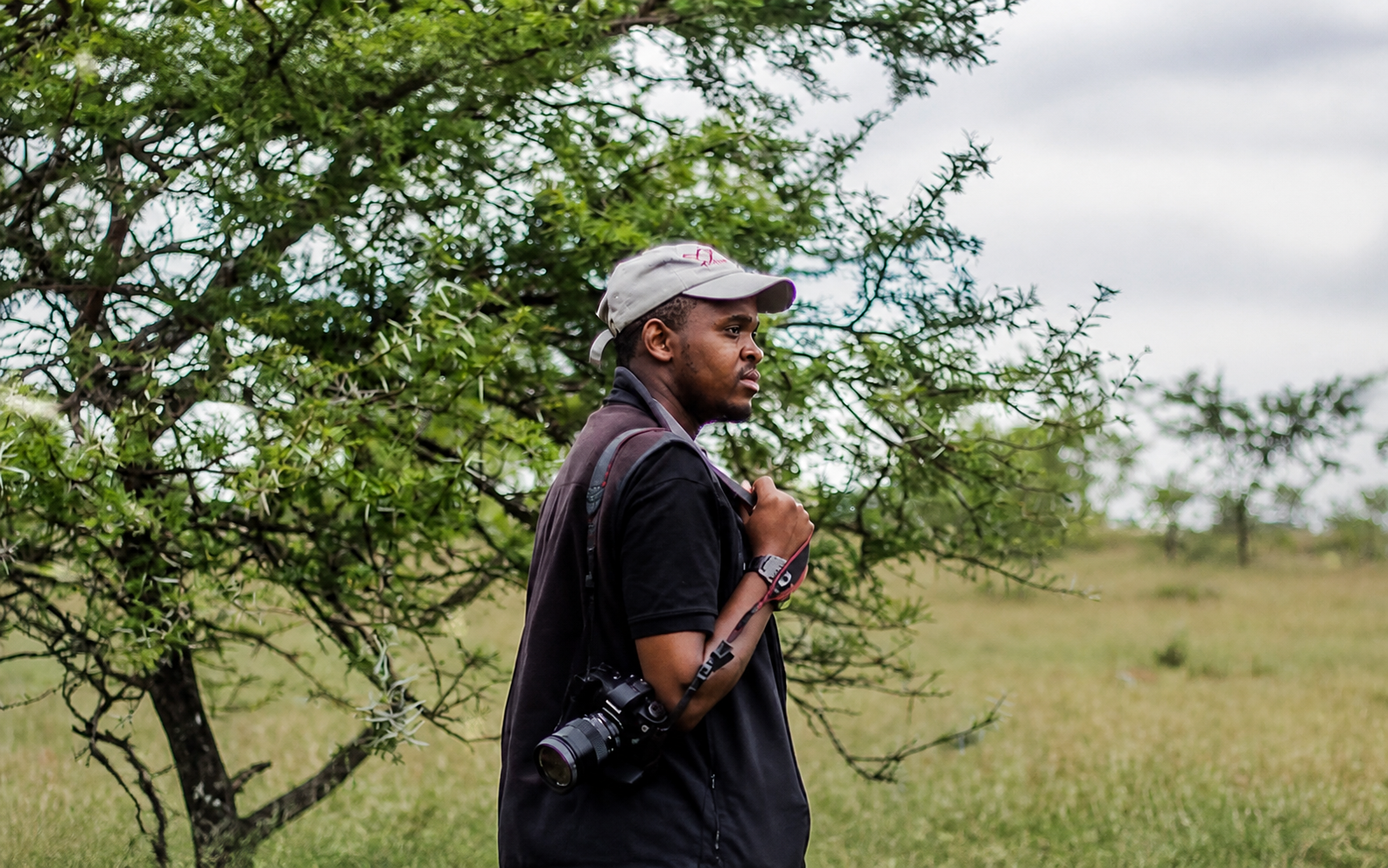 Gugulethu photographer Luvuyo Wogqoyi carrying his camera while seeking dialysis support